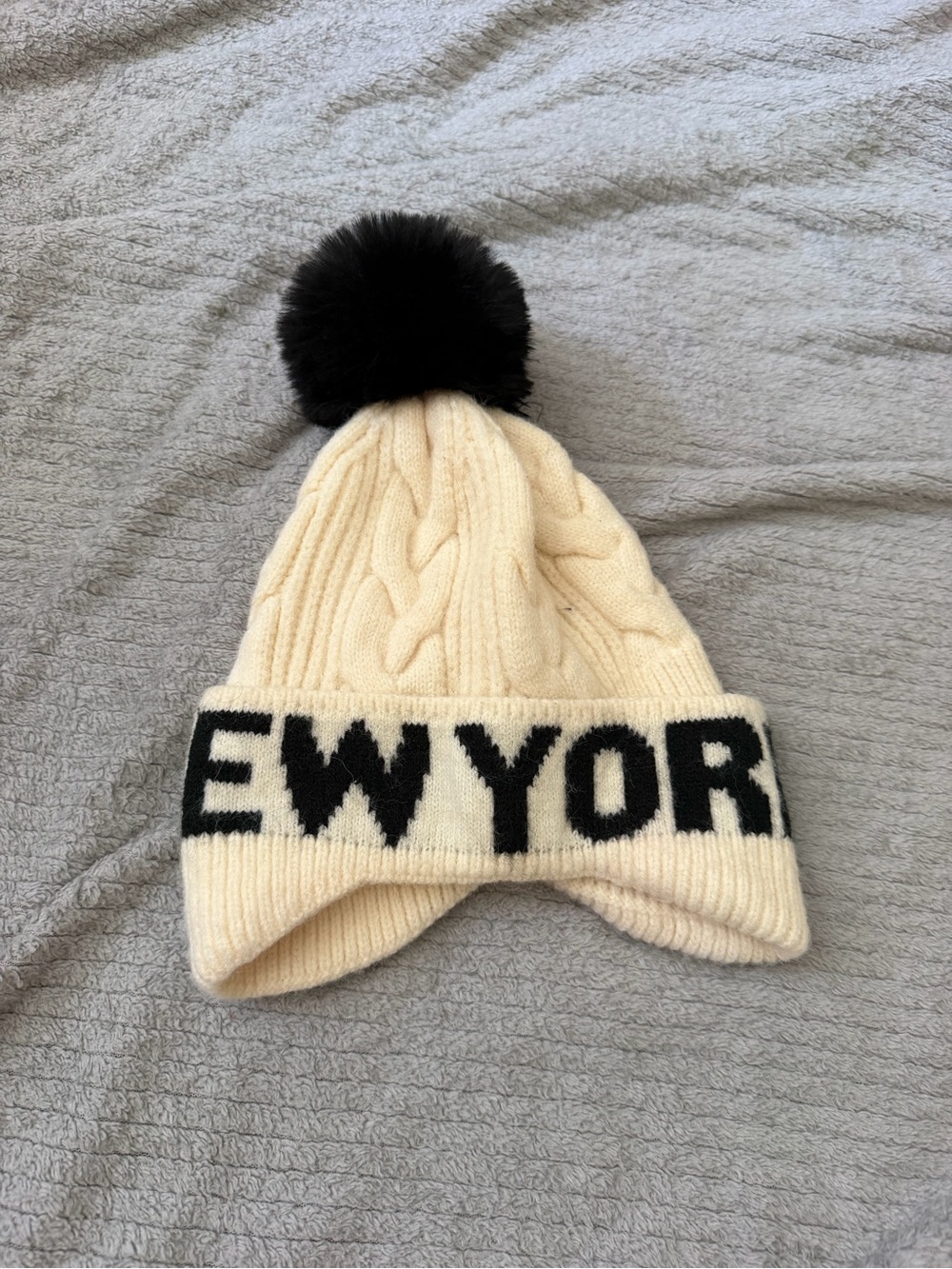 Robin Ruth Cream Cable Knit Pom Beanie with Black Lettering